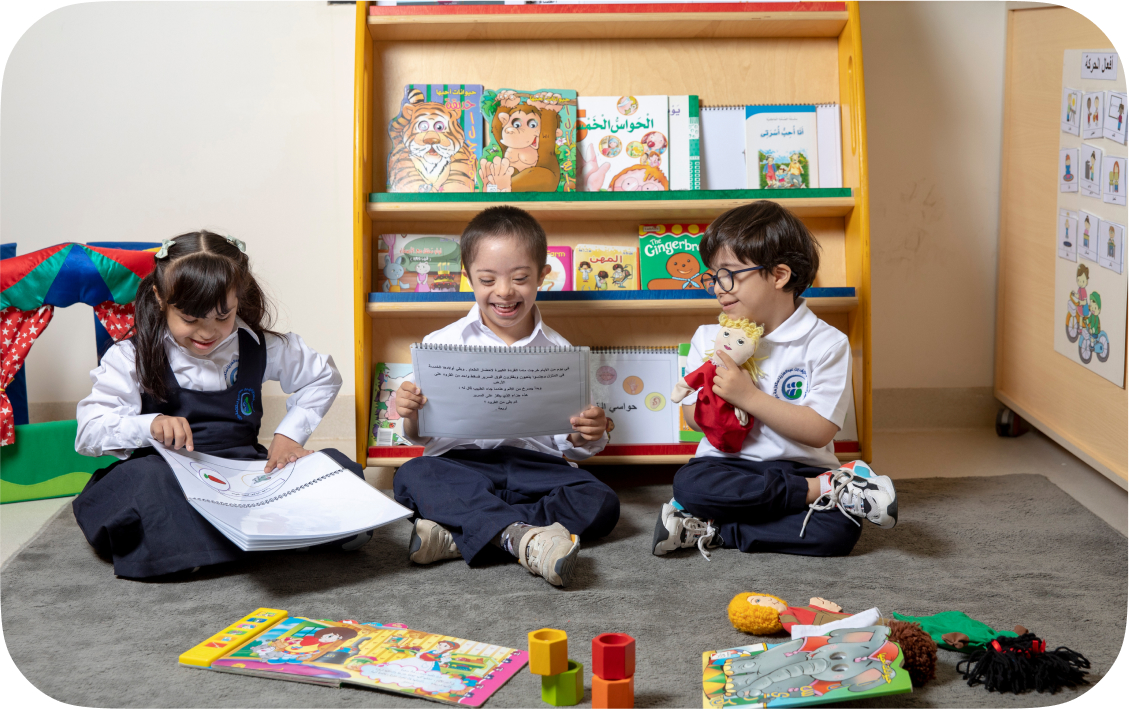 Three children sitting together with books, collaborative learning
